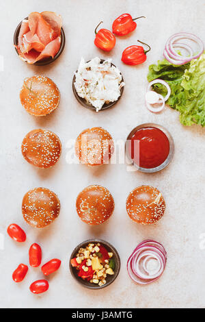 Preparing homemade burgers, various fillings on rustic surface. Top view, blank space Stock Photo