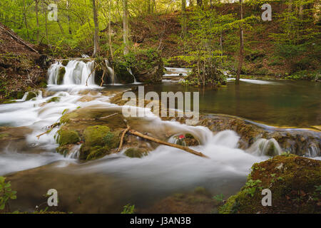 Beautiful small waterfall and rapids on a mountains river in springtime Stock Photo