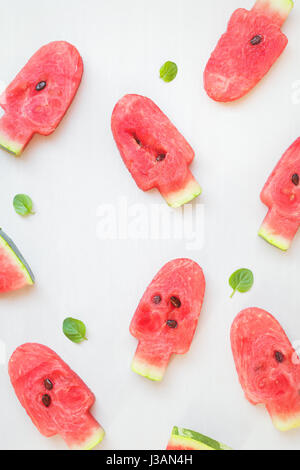 Watermelon shaped ice cream pops, flat lay Stock Photo