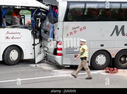 Brunnthal, Germany. 4th May, 2017. Two damaged busses on the A8 motorway near Brunnthal, Germany, 4 May 2017. Several children were slightly injured in a traffic accident involving two cars and two busses south of Munich. Photo: Alexander Heinl/dpa/Alamy Live News Stock Photo