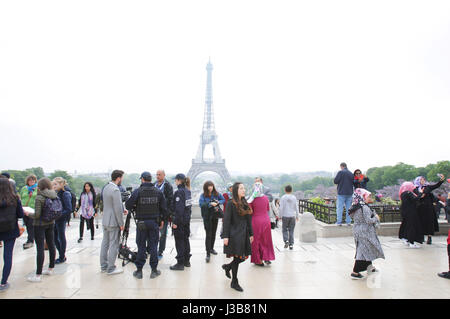 Paris, France. 05th May, 2017. French police officers check two men during patrol near the Eiffel Tower on May 5, 2017 as part of the 'Sentinelle' security plan in Paris, France. Credit: VWPics/Alamy Live News Stock Photo