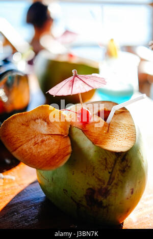 Fresh young coconut at the tropical beach resort in Asia, hot summer holiday Stock Photo