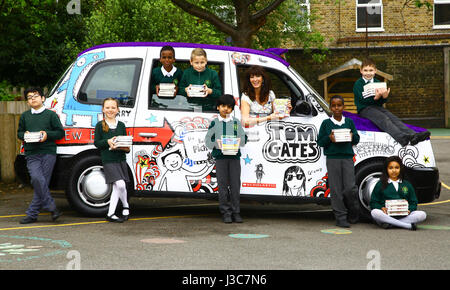 EDITORIAL USE ONLY Author Liz Pichon meets pupils at the launch of Scholastic&Otilde;s '100 Books for 100 Schools' giveaway with a Tom Gates themed taxi to celebrate the publication of her new book, Tom Gates: Family, Friends and Furry Creatures, at Drayton Green Primary School in Ealing, London. Stock Photo