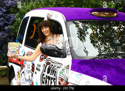 EDITORIAL USE ONLY Author Liz Pichon at the launch of Scholastic's '100 Books for 100 Schools' giveaway with a Tom Gates themed taxi to celebrate the publication of her new book, Tom Gates: Family, Friends and Furry Creatures, at Drayton Green Primary School in Ealing, London. Stock Photo