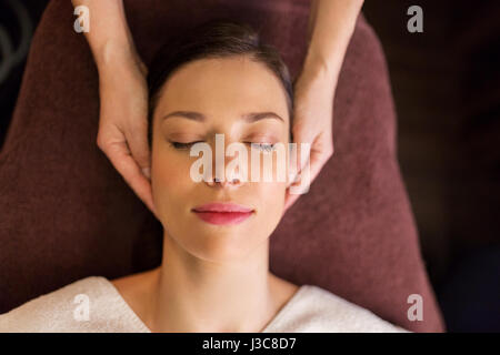 woman having face and head massage at spa Stock Photo