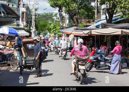 NHA TRANG, VIETNAM - DECEMBER 12: Rickshaw with his three-wheeled passenger cart on the street of Nha Trang on December 12, 2015 in Nha Trang, Vietnam Stock Photo