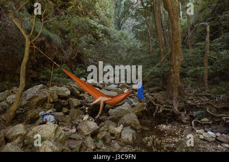 Woman relaxing in hammock at countryside Stock Photo