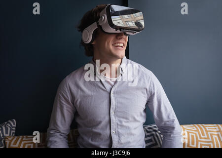 Happy man using virtual reality headset in cafÃƒÂ© Stock Photo