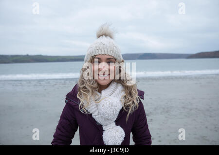 Portrait of woman standing on the beach Stock Photo