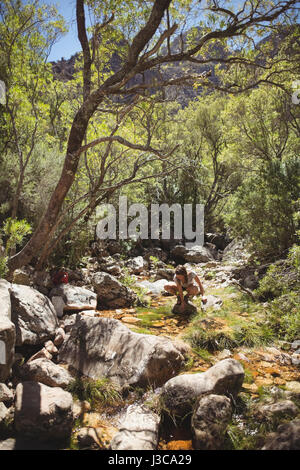 Women washing her face with a water on a sunny day Stock Photo