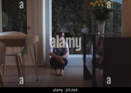 Beautiful woman sitting on the floor, white background Stock Photo - Alamy
