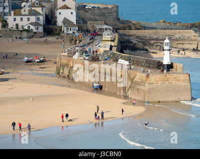 St. Ives Cornish seaside town, Sun catching Smeatons Pier and harbour beach in February near low tide, Cornwall England. Stock Photo