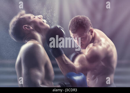 Two professional boxers fighting in the ring Stock Photo