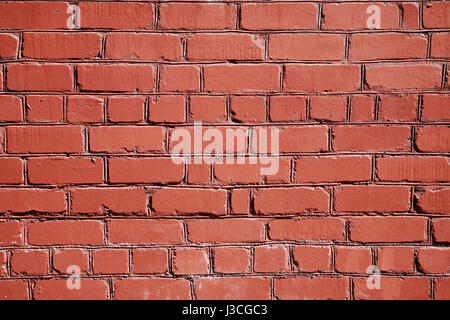 Red brick wall painted with red paint Stock Photo