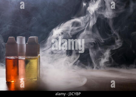 isolated vape e liquid  for electronic cigarette on a dark background. Stock Photo