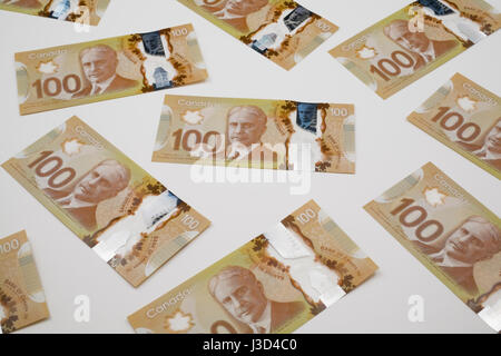 New Canadian 100 dollar bills on a white background Stock Photo
