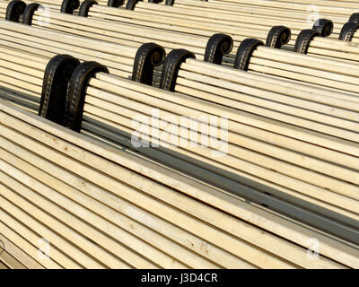 Backgrounds and textures: big group of park benches, new and clean, arranged in rows Stock Photo