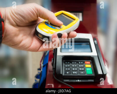 Paying self service for grocery shopping with hand held eletctronic scanner. Stock Photo