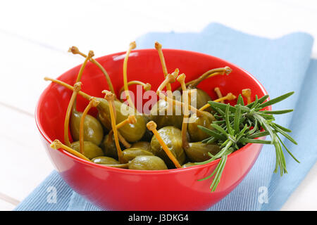 bowl of pickled caper berries with stems on Stock Photo