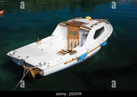 Small white and blue fishing boat moored in Cavtat harbour, Dalmatia region, Croatia, Eastern Europe. Stock Photo