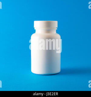 Pill bottle on blue background Stock Photo