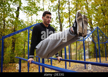 Doing Triceps Dips on Parallel Bars Stock Photo