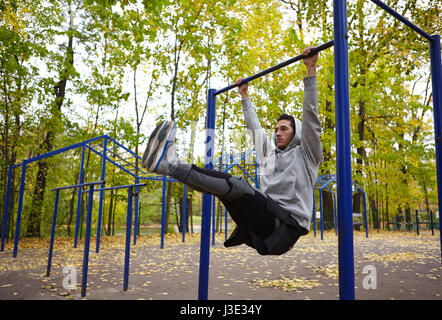 Doing Pull-ups on Horizontal Bar Stock Photo