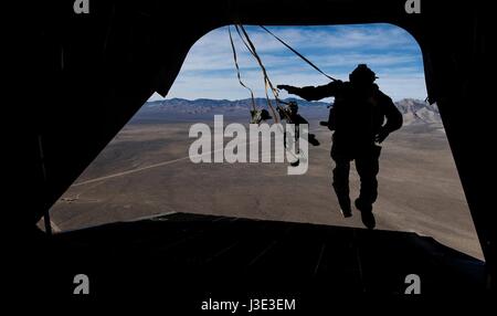 USAF soldiers perform static line parachute jump out of a U.S. Army CH-47 Chinook helicopter during exercise Red Flag over the Nellis Air Force Base Nevada Test and Training Range March 7, 2017 near Las Vegas, Nevada.    (photo by Kevin Tanenbaum /US Air Force  via Planetpix) Stock Photo