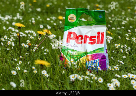 Persil washing powder on a meadow full of dandelions and daisies