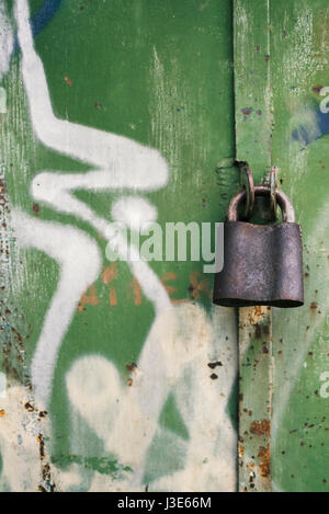 Old padlock on a background of painted doors Stock Photo