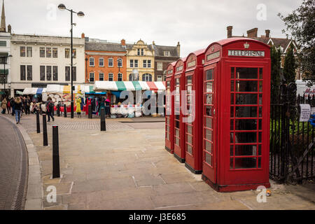 The University city of Cambridge in England with traditional red telephone boxes in the street near the market Stock Photo