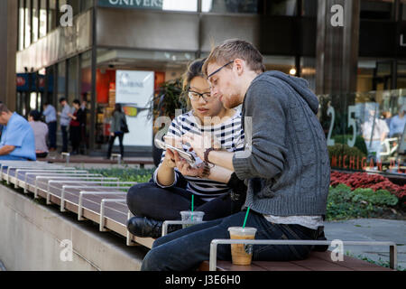 Couple using smartphones. Michigan Avenue, Chicago, Illinois. Stock Photo