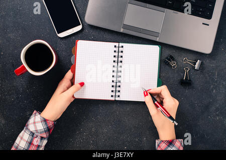 Female hands writing in empty notebook Stock Photo