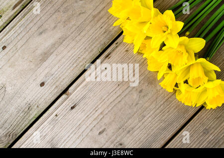 Yellow daffodils on wooden table Stock Photo