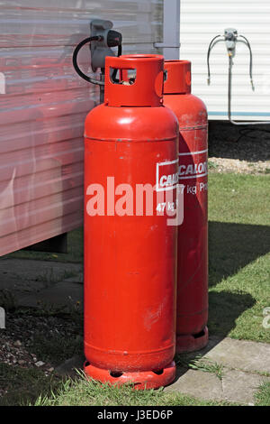 Two 47kg Calor Gas Bottles hooked up to a static caravan on a holiday caravan park Stock Photo
