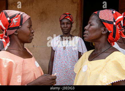 BURKINA FASO, Kaya, aid project of catholic church for forced married women in Boken , three women with headscarf with white bird, waxprint, wax print, fabric, design, batik Stock Photo