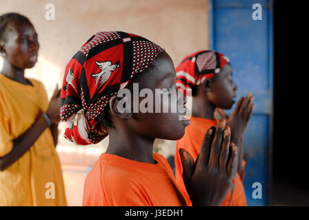 BURKINA FASO, Kaya, aid project of catholic church for forced married girls in Boken, young girl with wax print headscarf with image of white bird Stock Photo