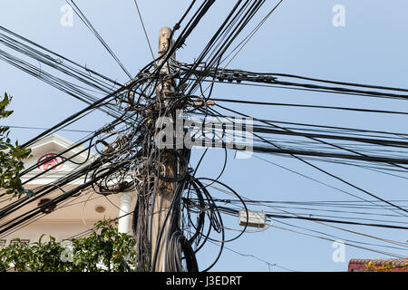 Hoi An, Vietnam - march 11 2017: typical messy cable infrastructure in Vietnam. The result of such solution is lack of electricity or Internet during  Stock Photo