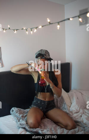 Young woman smoking a bong Stock Photo