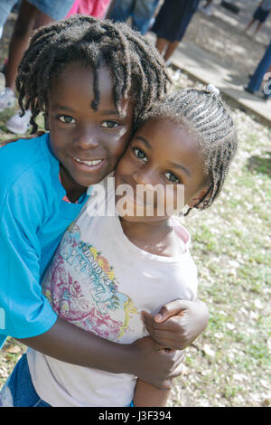 Miami Florida,Little Haiti,Range Park,Back to School Black girl girls,youngster,female kids children hug Inner City Youth Center,centre,ICYC,urban,par Stock Photo