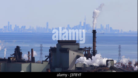 Hamilton industrial area with Toronto skyline behind Stock Photo