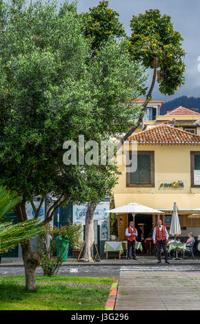 Madeiran waiters wearing colourfull waistcoats outside a restaurant in Funchal Stock Photo