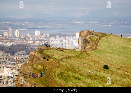 Edinburgh, Scotland, UK - March 20, 2015: Crowds gather on Edinburgh's Salisbury Crags in Holyrood Park, to observe the partial solar eclipse. Stock Photo