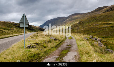 The A896 road meanders through the moorland valley of Glen Shieldaig, under Ben Shieldaig mountain, near Torridon in the west Highlands of Scotland. Stock Photo
