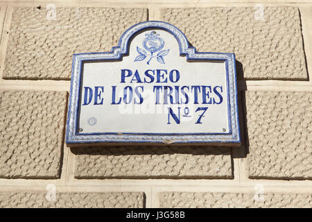 Paseo de los Tristes. Traditional glazed street sign decorated with pomegranate in El Albayzin district in Granada, Andalusia, Spain. Stock Photo