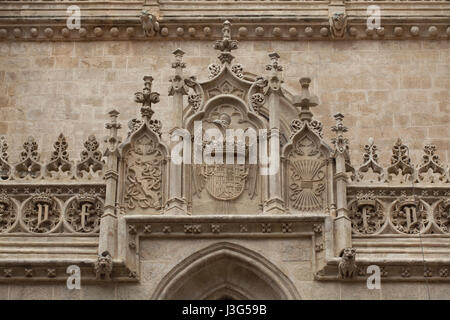 Coat of arms of the Catholic Monarchs (Los Reyes Catolicos) depicted on the facade of the Royal Chapel (Capilla Real de Granada) where Queen Isabella I of Castile and King Ferdinand II of Aragon are buried in Granada, Andalusia, Spain. Stock Photo