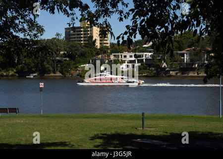 Brisbane, Australia: CityCat ferry on Brisbane River passing homes and apartments at St Lucia, viewed from Hill End Stock Photo