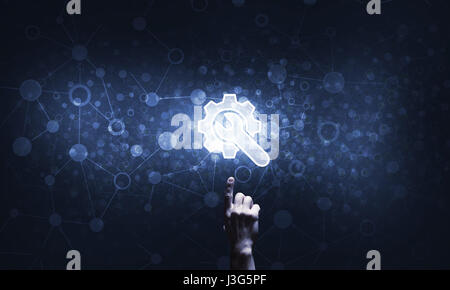 Close of human hand touching with finger setting glowing icon Stock Photo