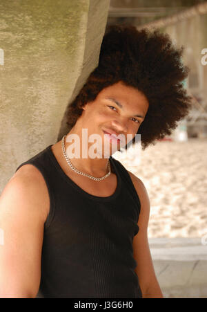 Young man with afro hairstyle on the beach Stock Photo