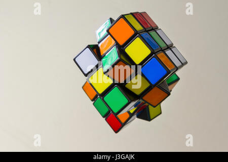 A Rubik's Cube sitting on a mirror. Stock Photo